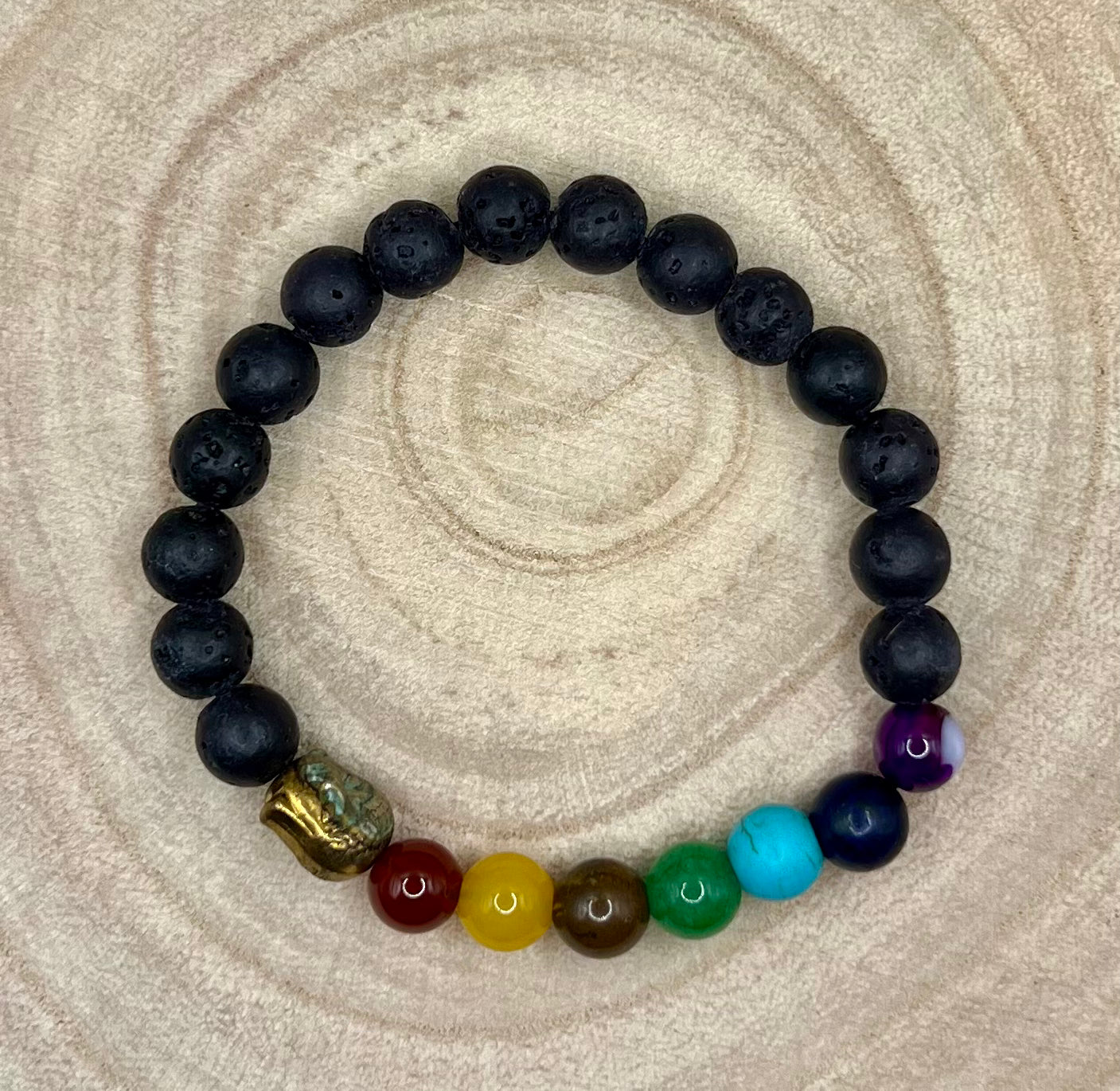 Personal / Lava bead aromatherapy bracelet. Absorbent volcanic rock beads with Buddha charm and chakra colour theme beads.