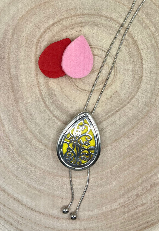 Pendant aromatherapy diffuser necklace with spare felt pads.